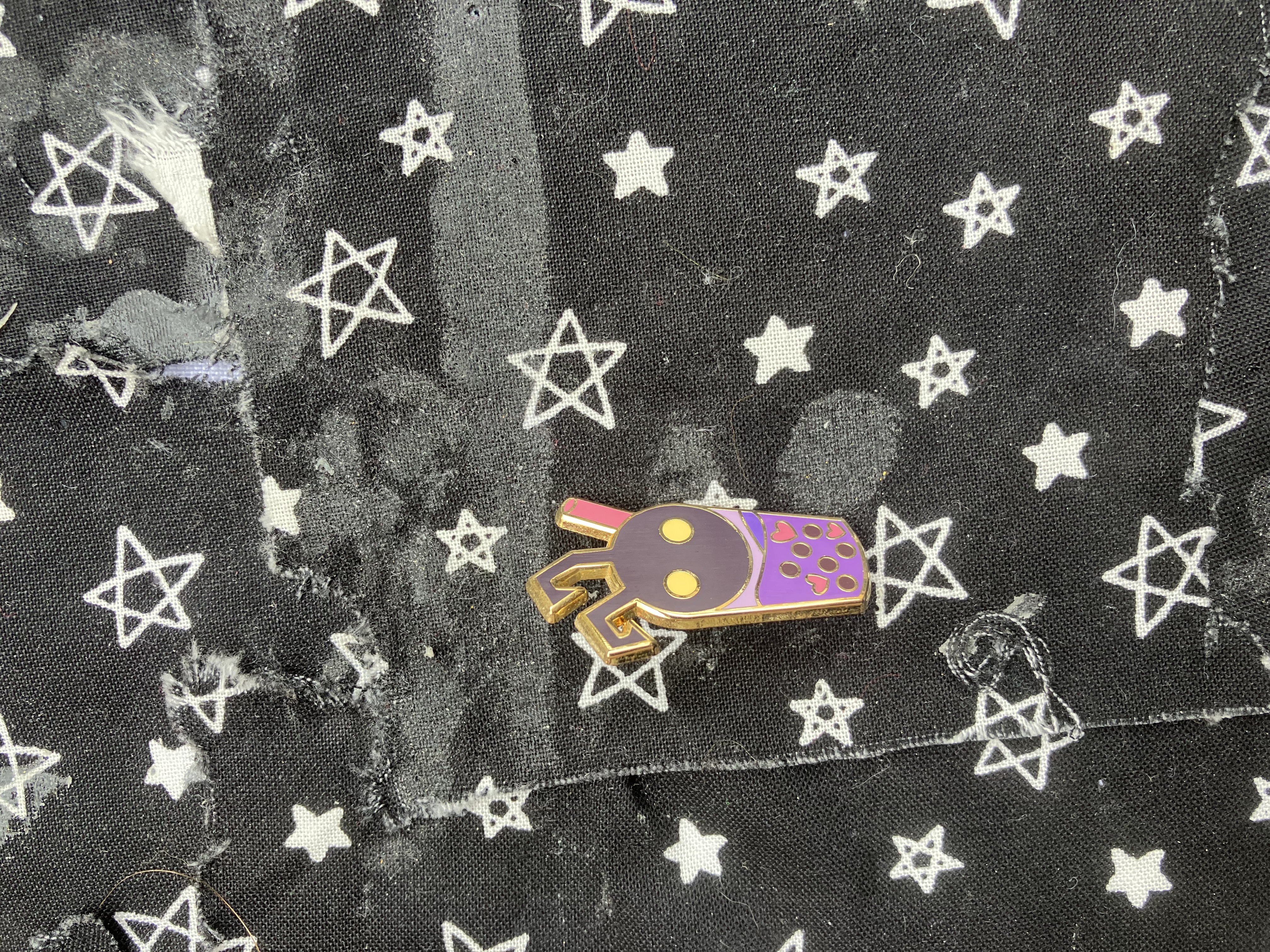 Enamel pin of a boba cup shaped like a Kingdom hearts heartless.